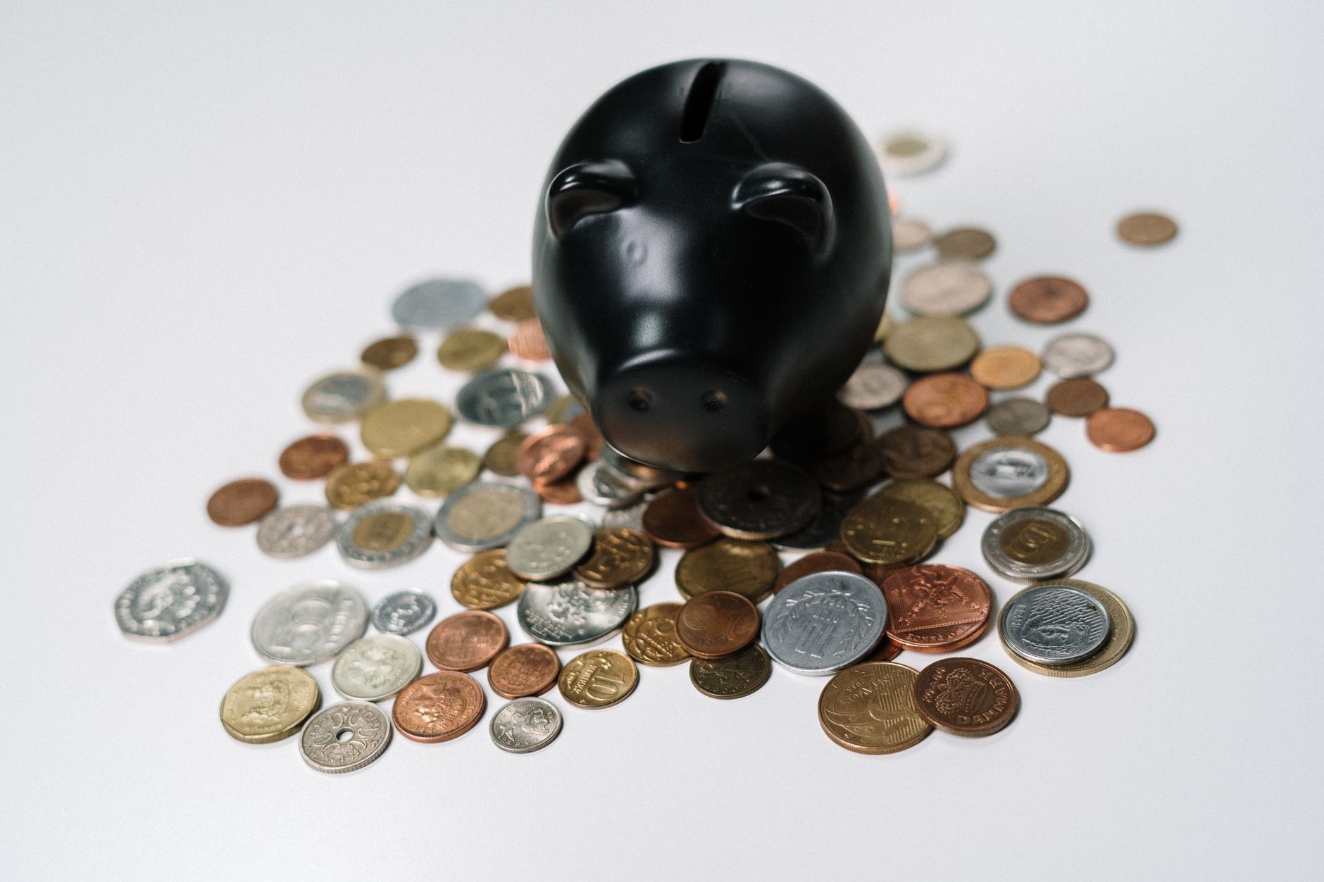 A small piggy bank surrounded by coins, symbolizing savings and financial growth.