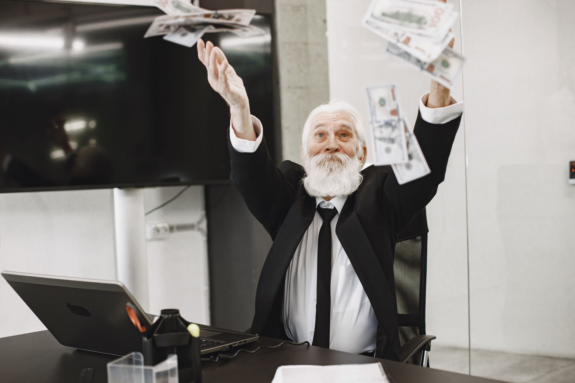A person jumping for joy with a graph showing financial progress, symbolizing motivation and success in paying off credit card debt.
