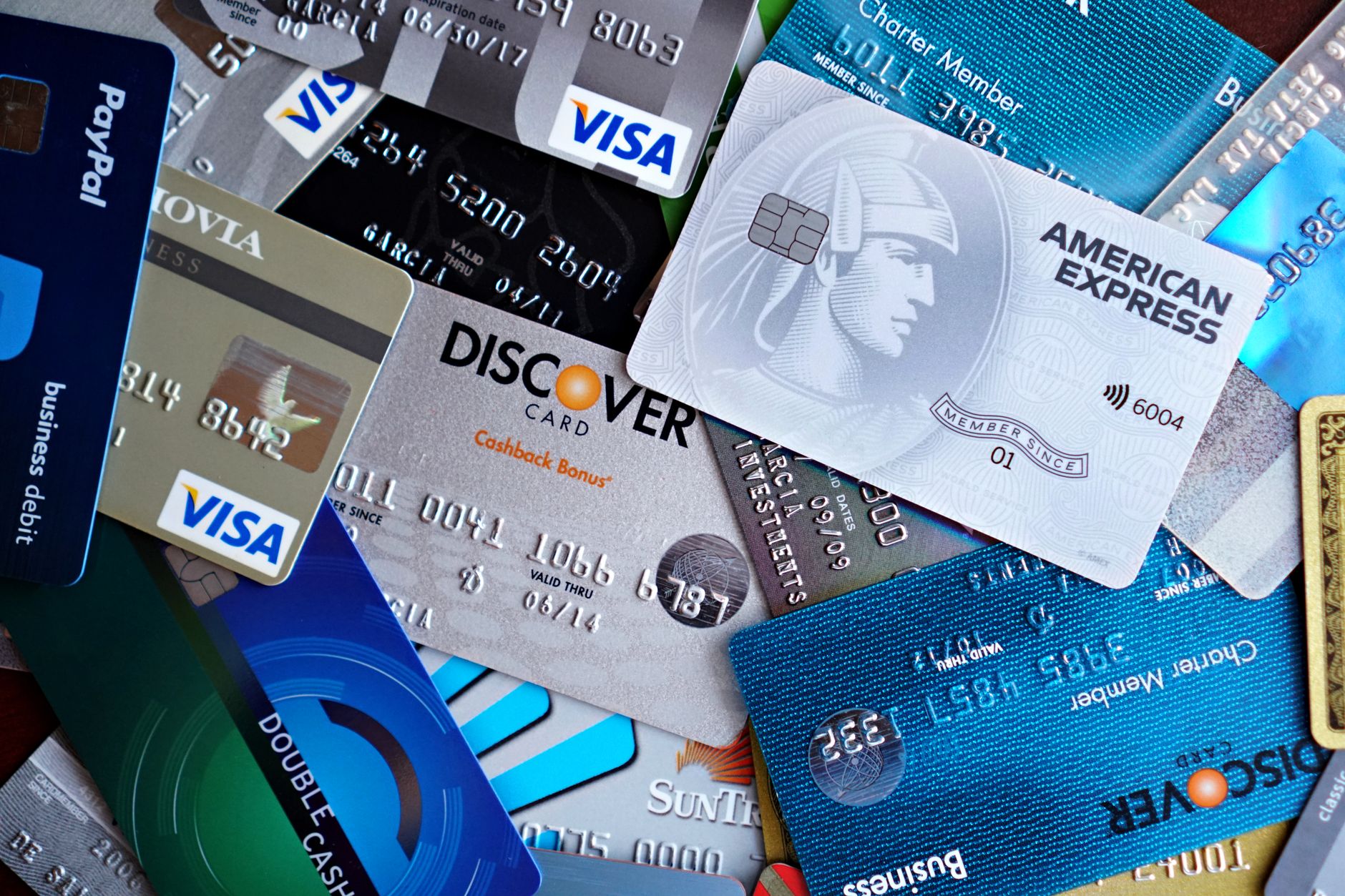 A close-up of a credit card being cut in half, representing debt payoff before beginning to invest.