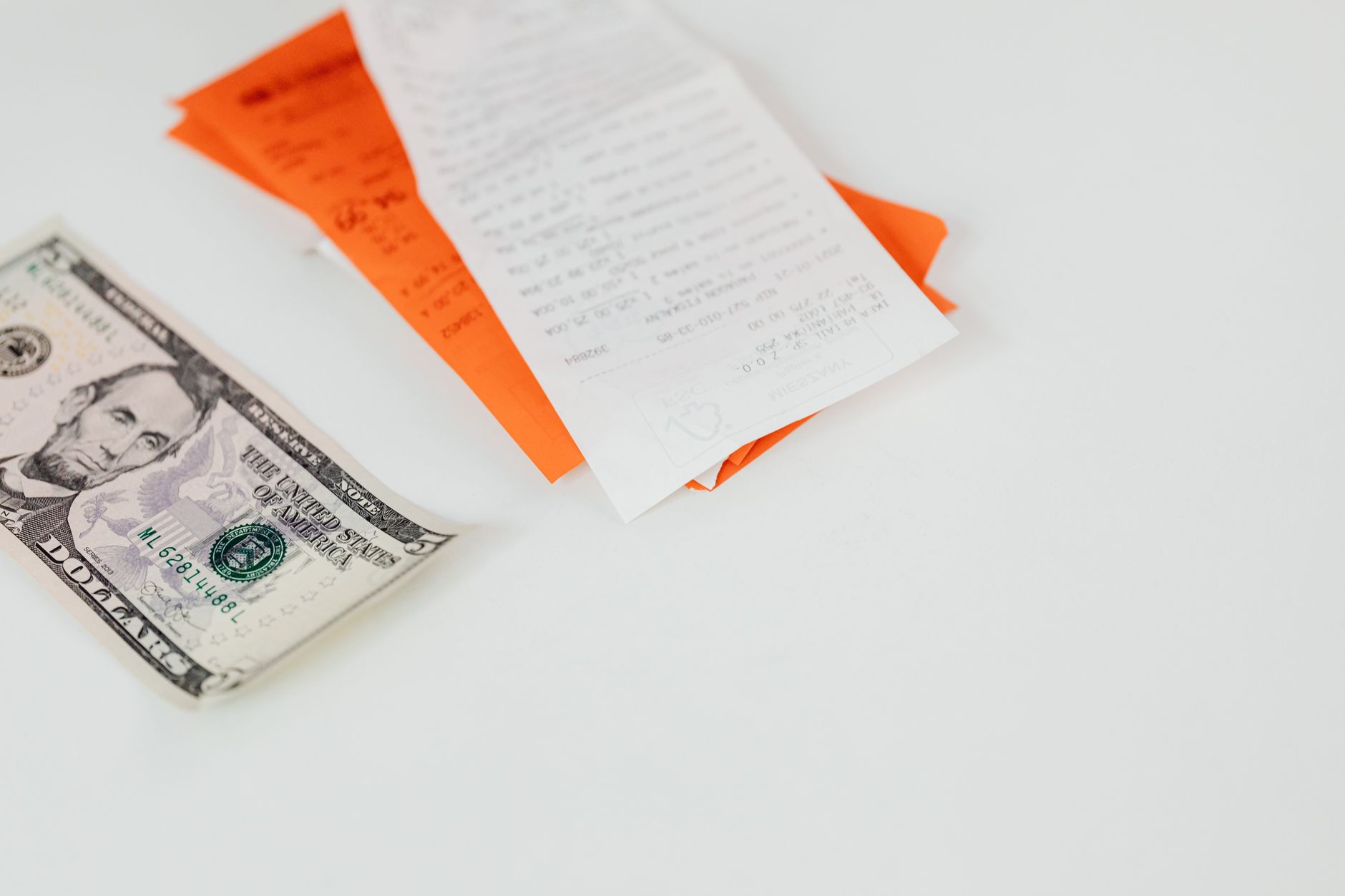 A close-up of a medical bill being paid with a debit card representing HSA expenses