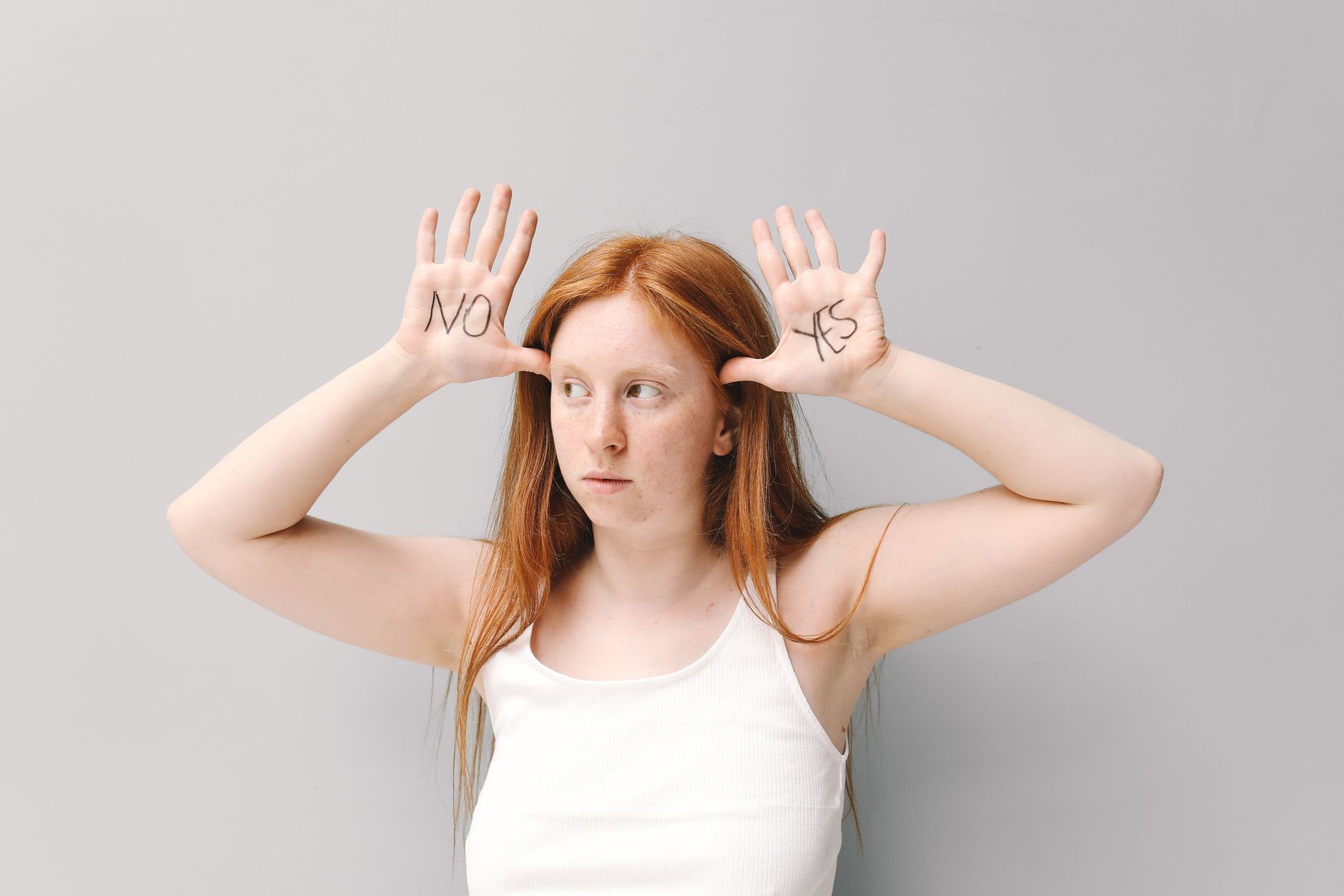 A person stands at a crossroads, looking at two signs pointing to 'Index Funds' and 'ETFs', symbolizing a financial decision.