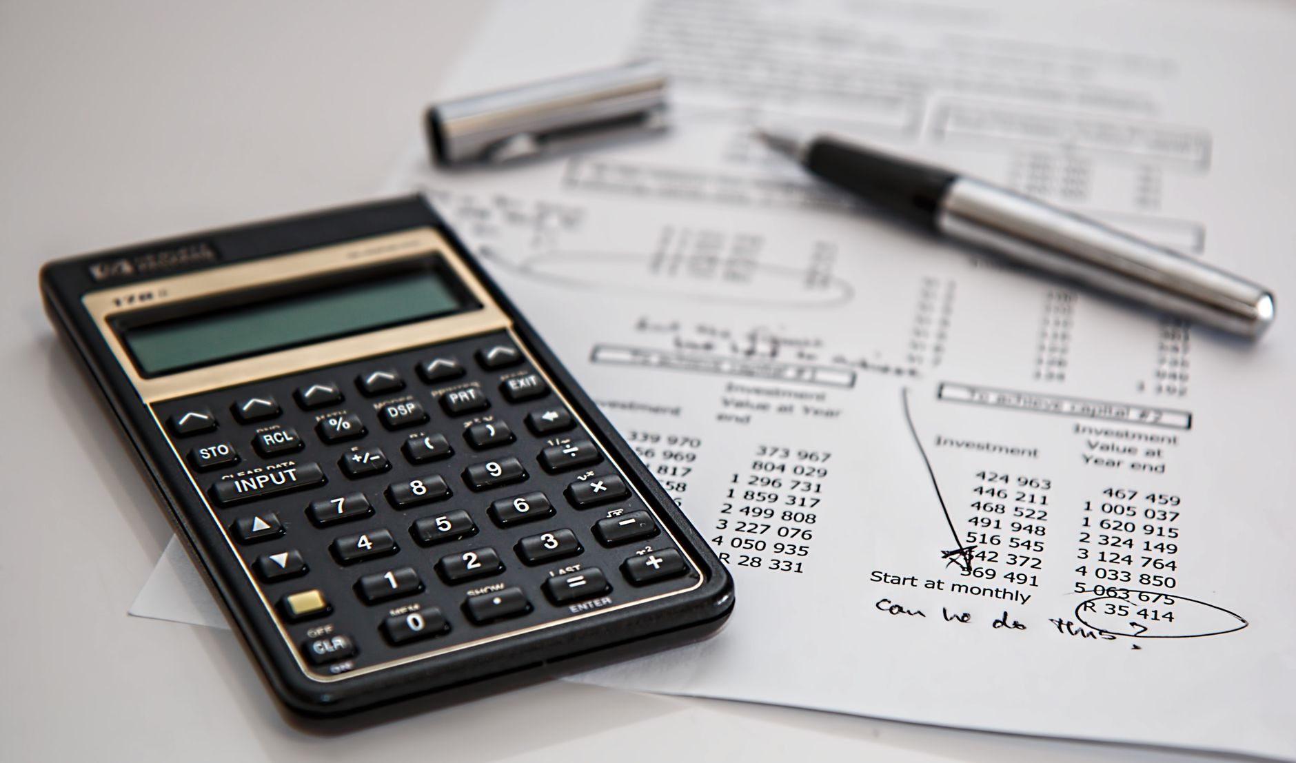 A person using a calculator to work out how much term life insurance coverage they need