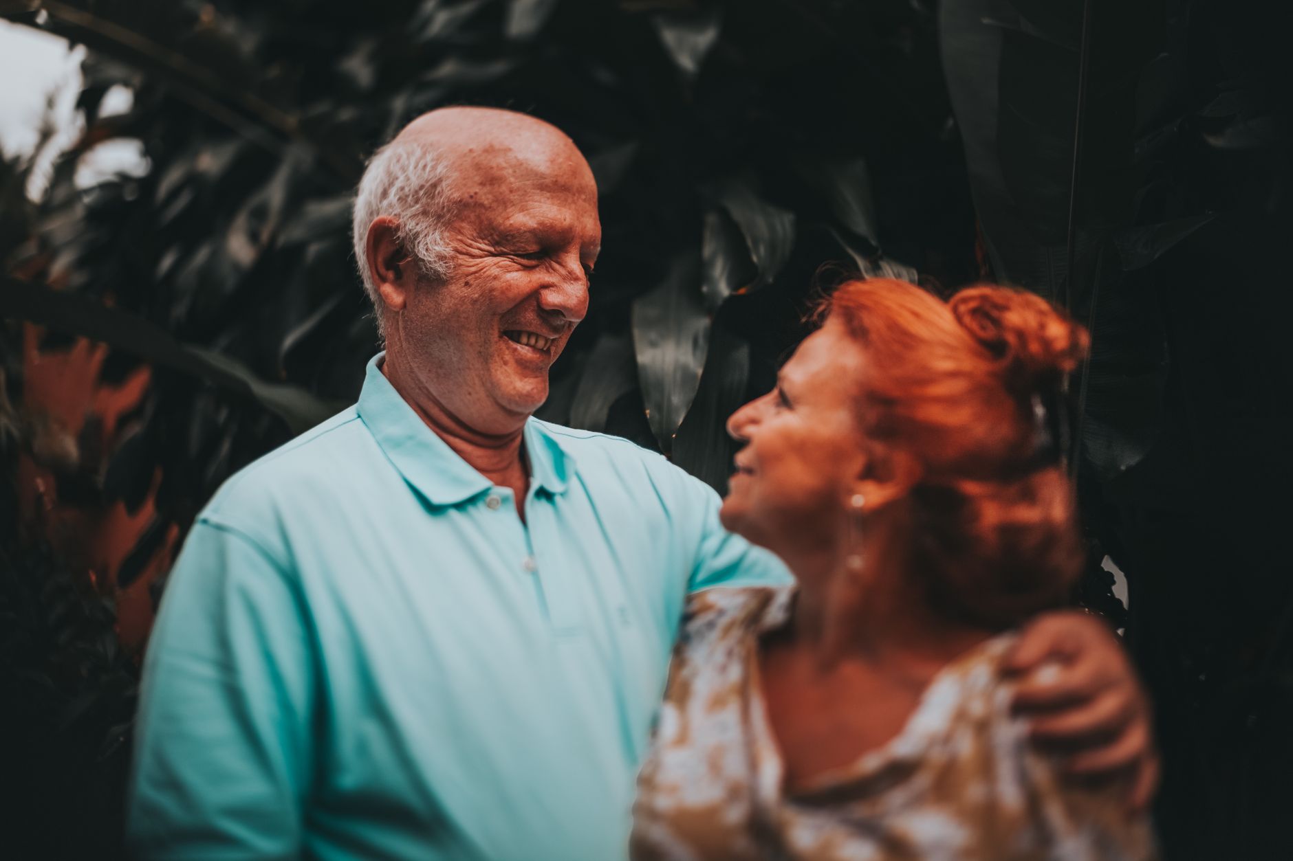 A happy retired couple walking along a beach representing financial freedom and flexible retirement planning