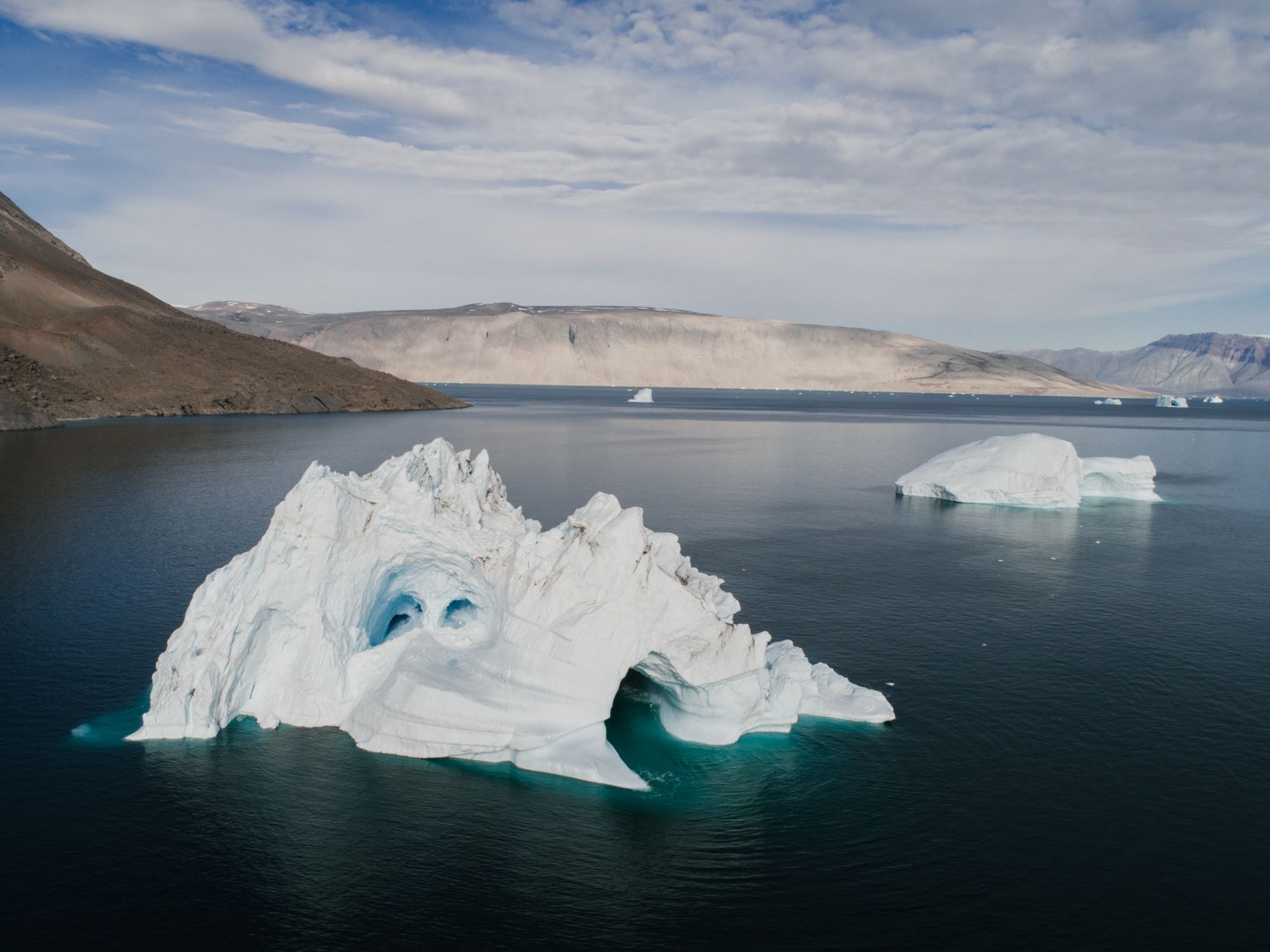 Iceberg graphic with expense ratio visible above water and transaction costs, bid-ask spreads, and tax drag below