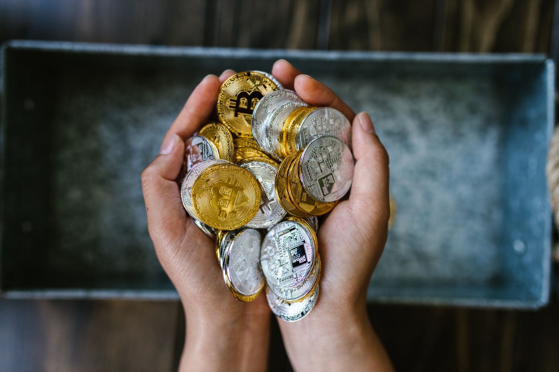 Hands holding gold coins representing the growth of a tax-advantaged backdoor roth ira retirement account