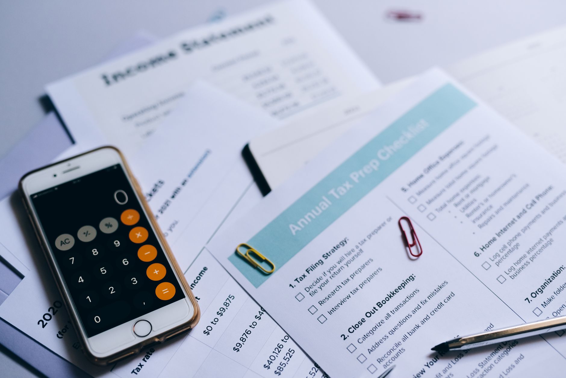 Tax forms and a calculator on a wooden desk showing tax optimization strategies
