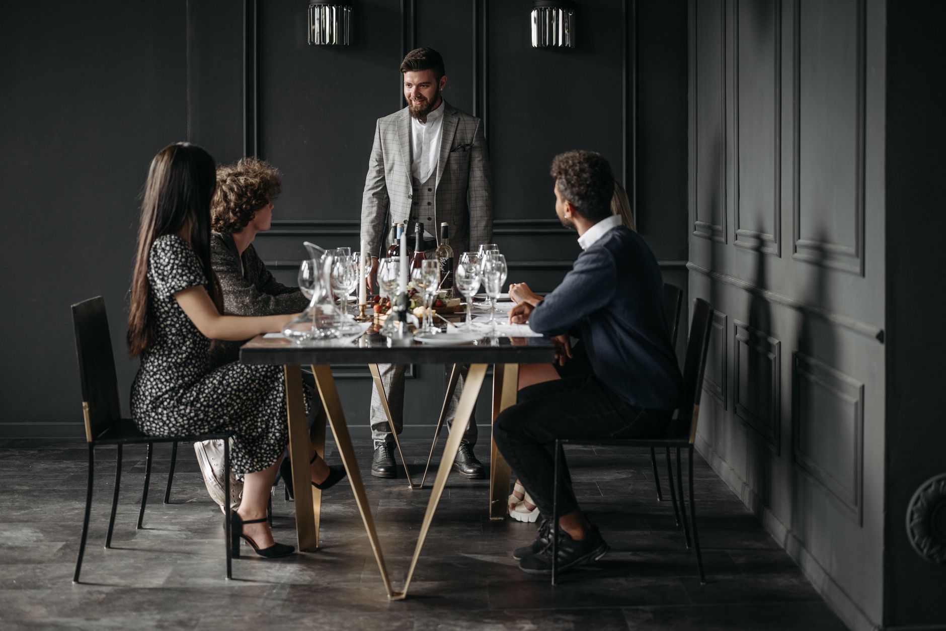 Friends dining at an upscale restaurant showcasing lifestyle inflation spending habits