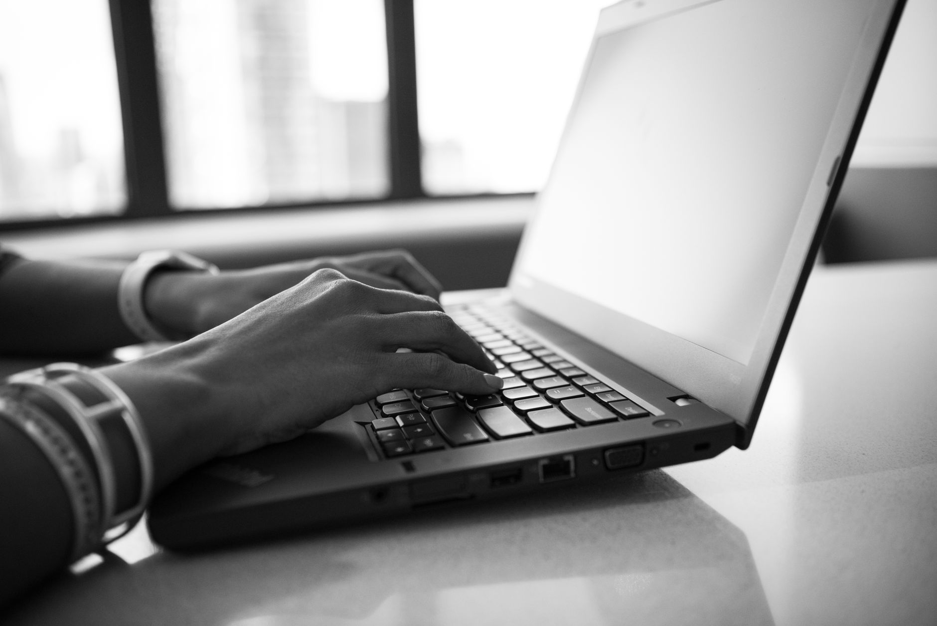 Two people discussing credit card statements on a modern laptop