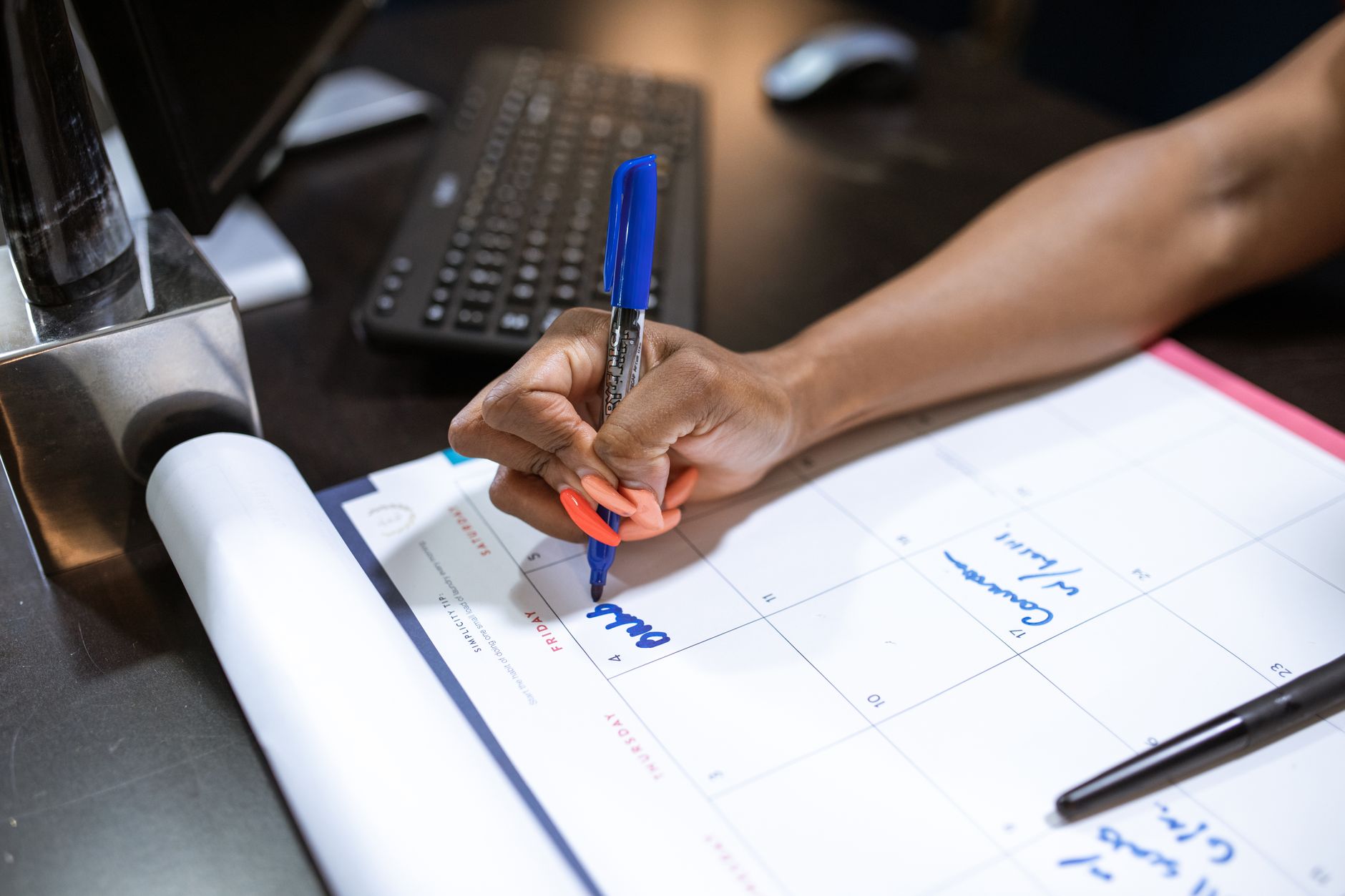A clean desk calendar showing planned financial goals and payment due dates