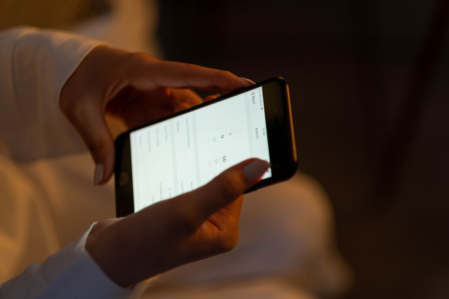 A person managing their personal investments on a mobile app instead of a traditional advisor
