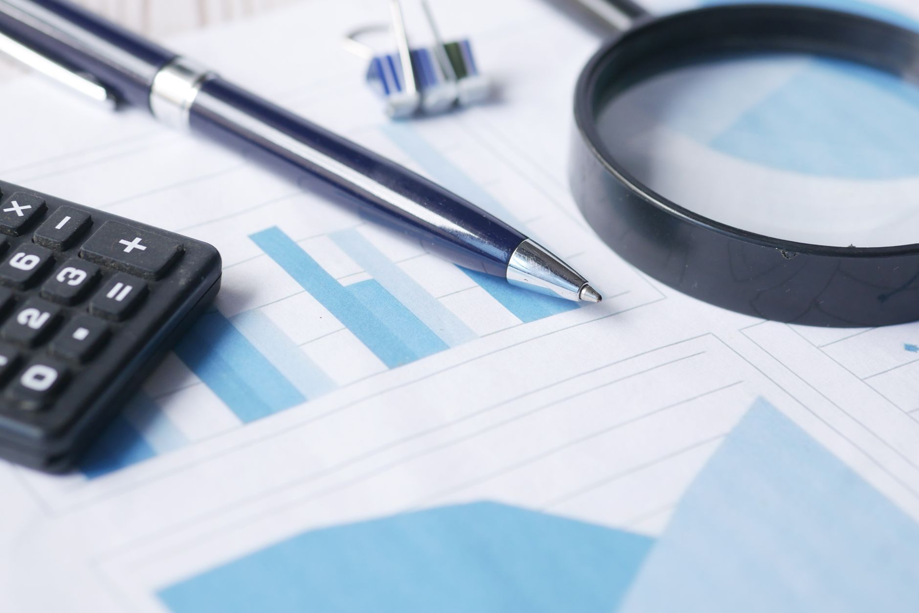 A person reviewing a financial spreadsheet on a desk, representing a comprehensive budget audit