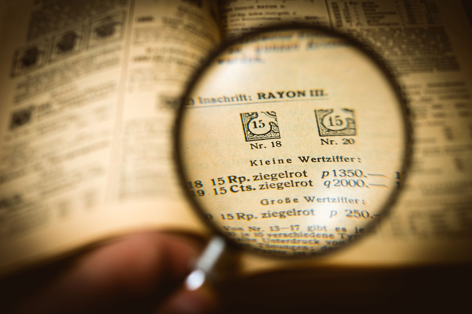 A magnifying glass focusing on the fine print of an insurance policy contract.