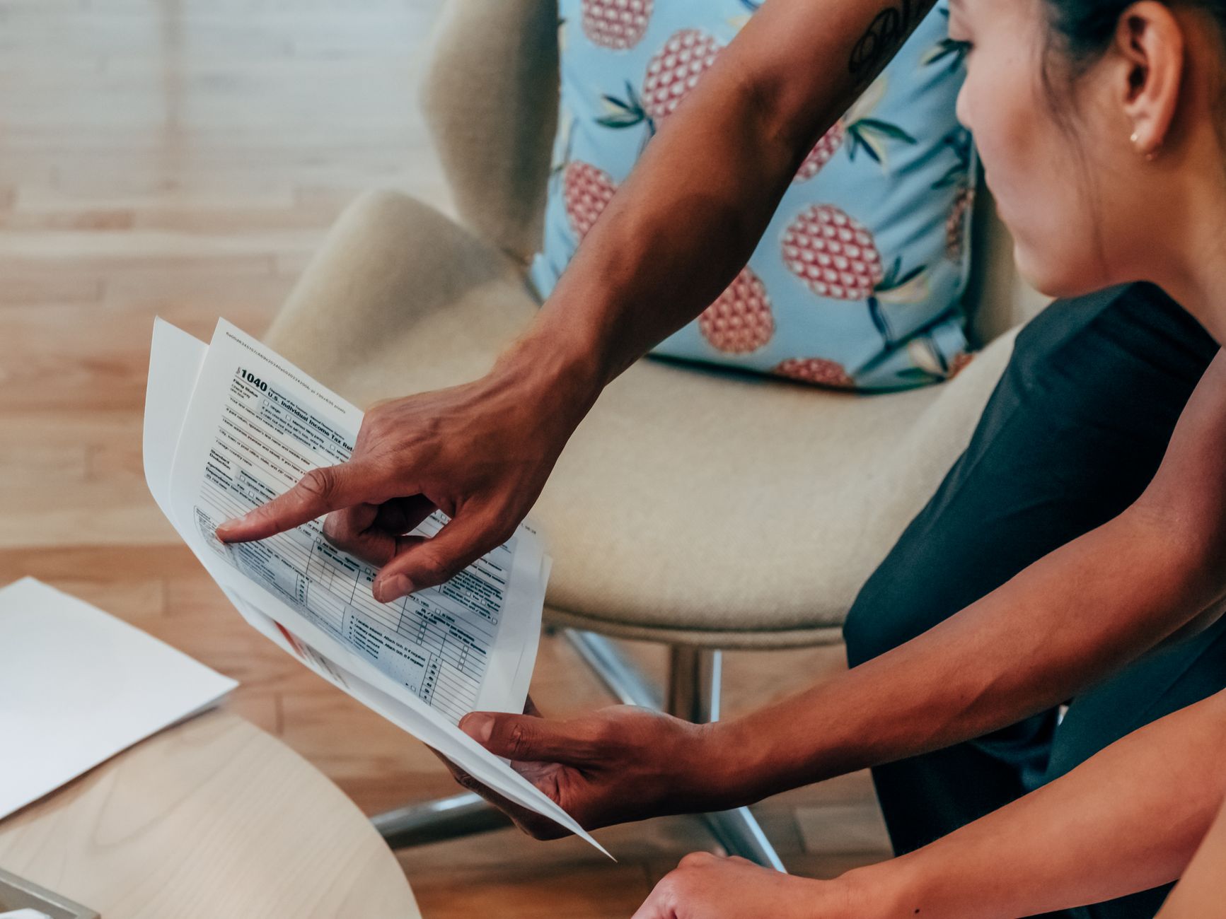 A thoughtful individual analyzing retirement account statements at a wooden desk