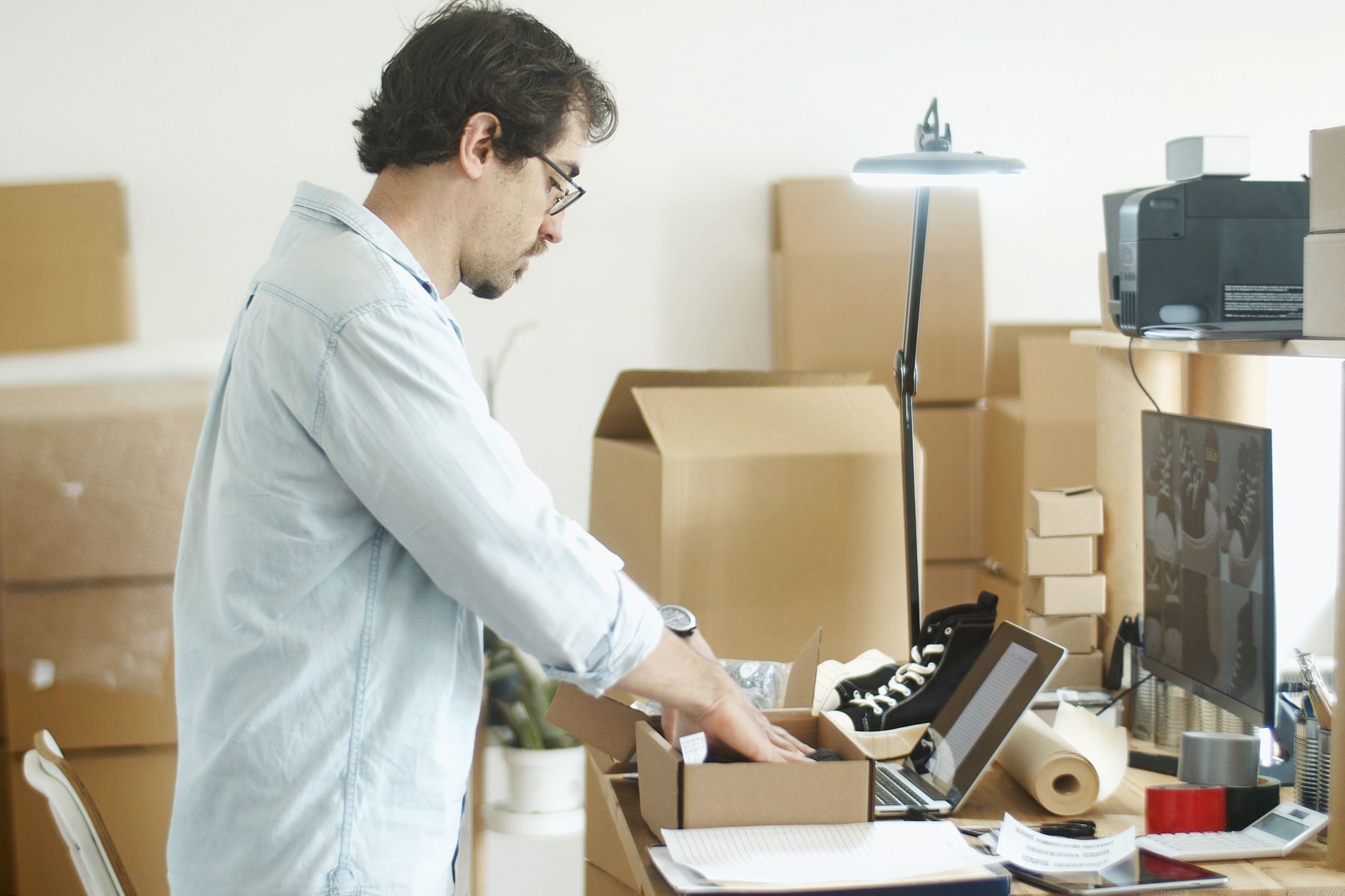 A worker packing their belongings into a box while transitioning to a new job
