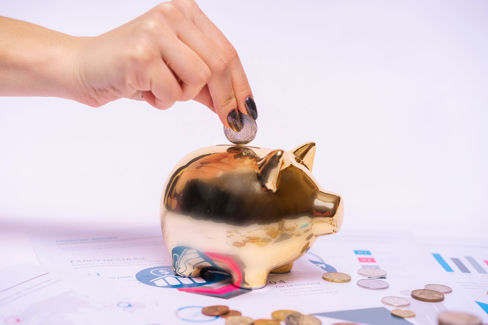A small green plant growing out of a ceramic piggy bank filled with coins