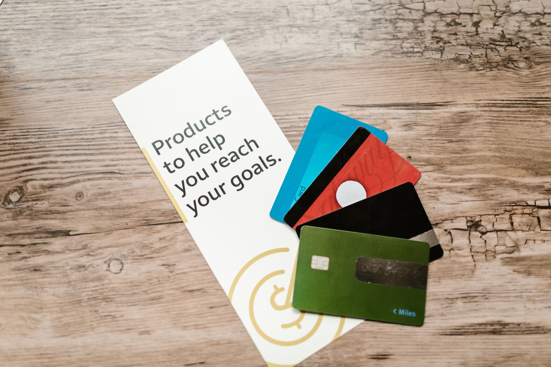 A fan of three to four credit cards showing different issuers and designs representing multiple revolving accounts