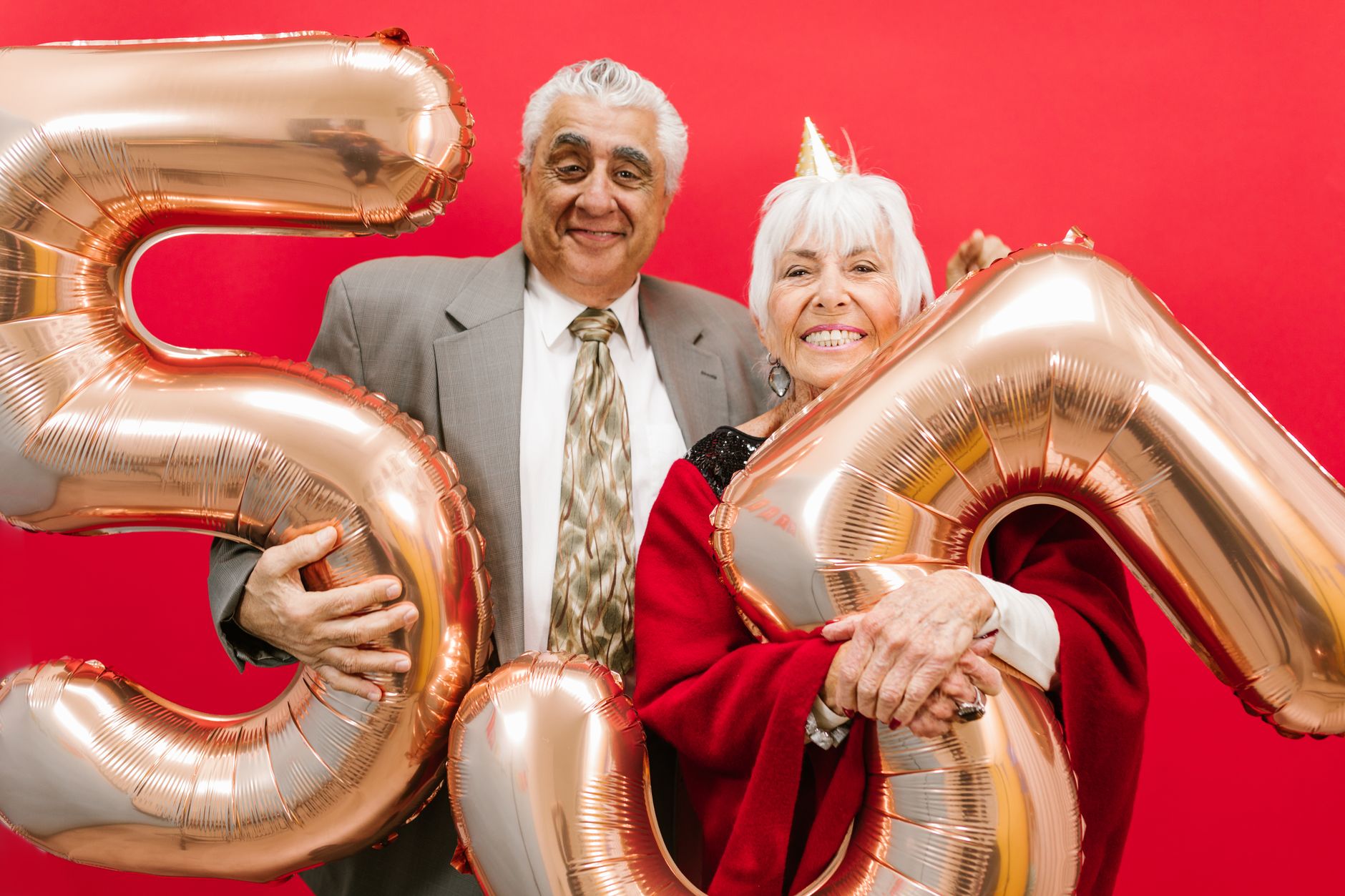 A happy couple raising glasses at a retirement party