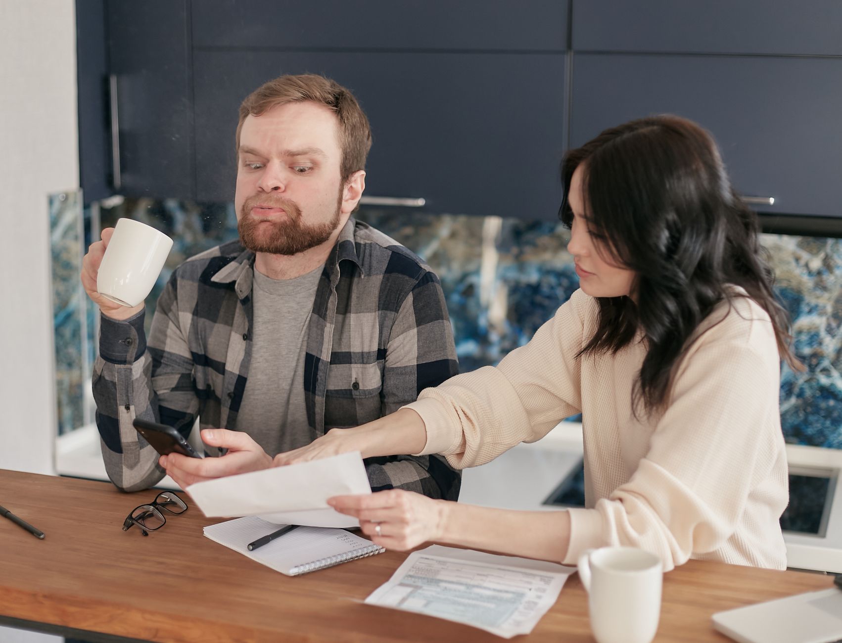 A multigenerational family sitting around a table reviewing paperwork
