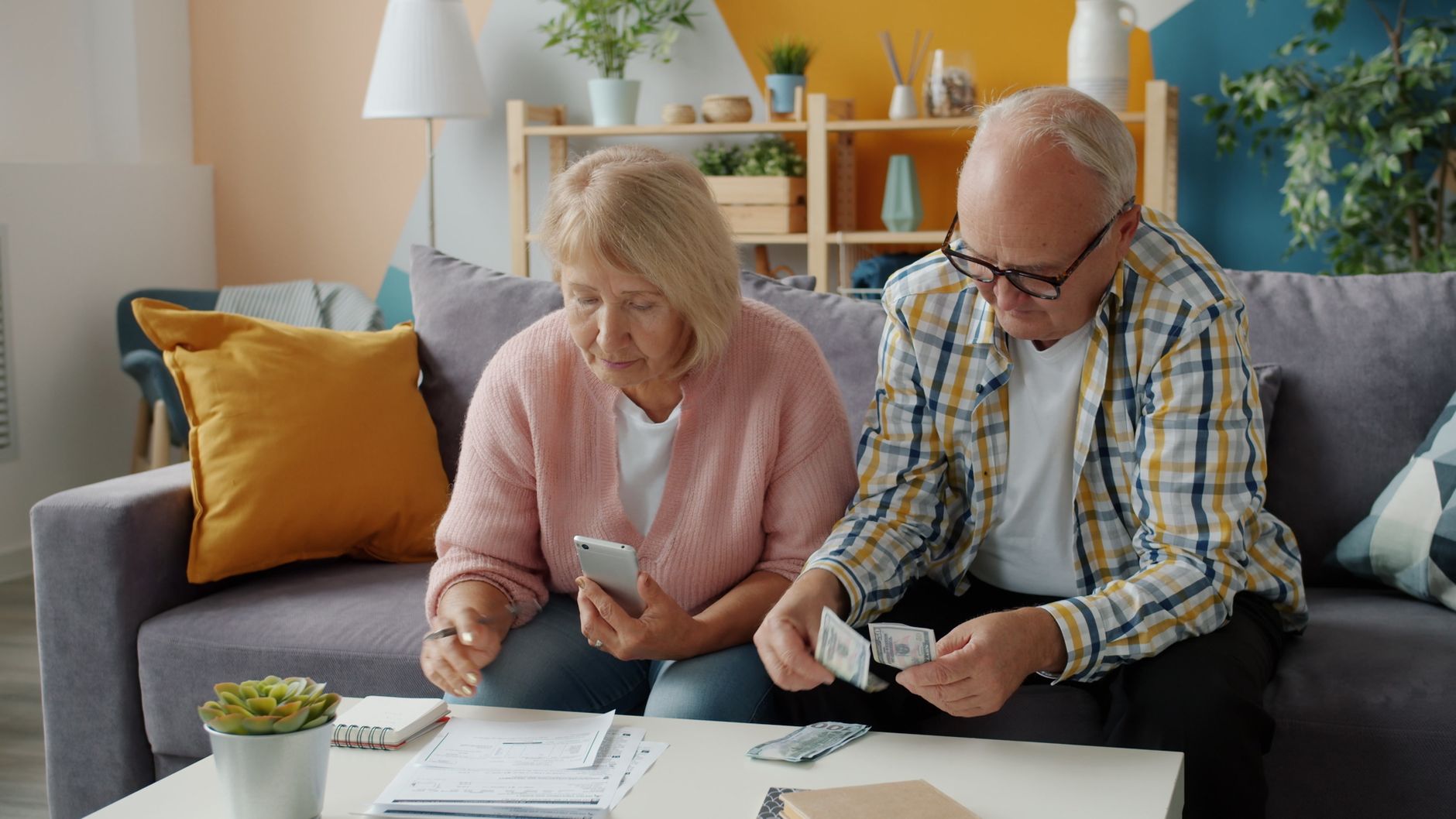A person using a retirement calculator on a laptop to plan catch-up contributions after age 50