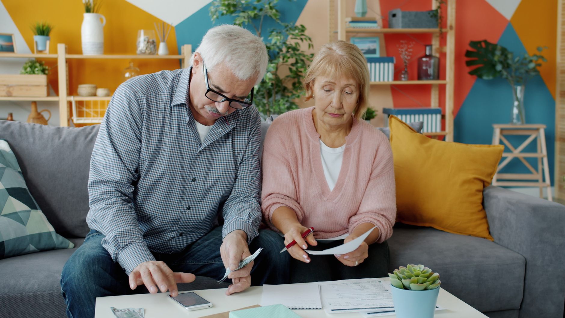 A couple in their early 60s reviewing retirement accounts on a tablet together