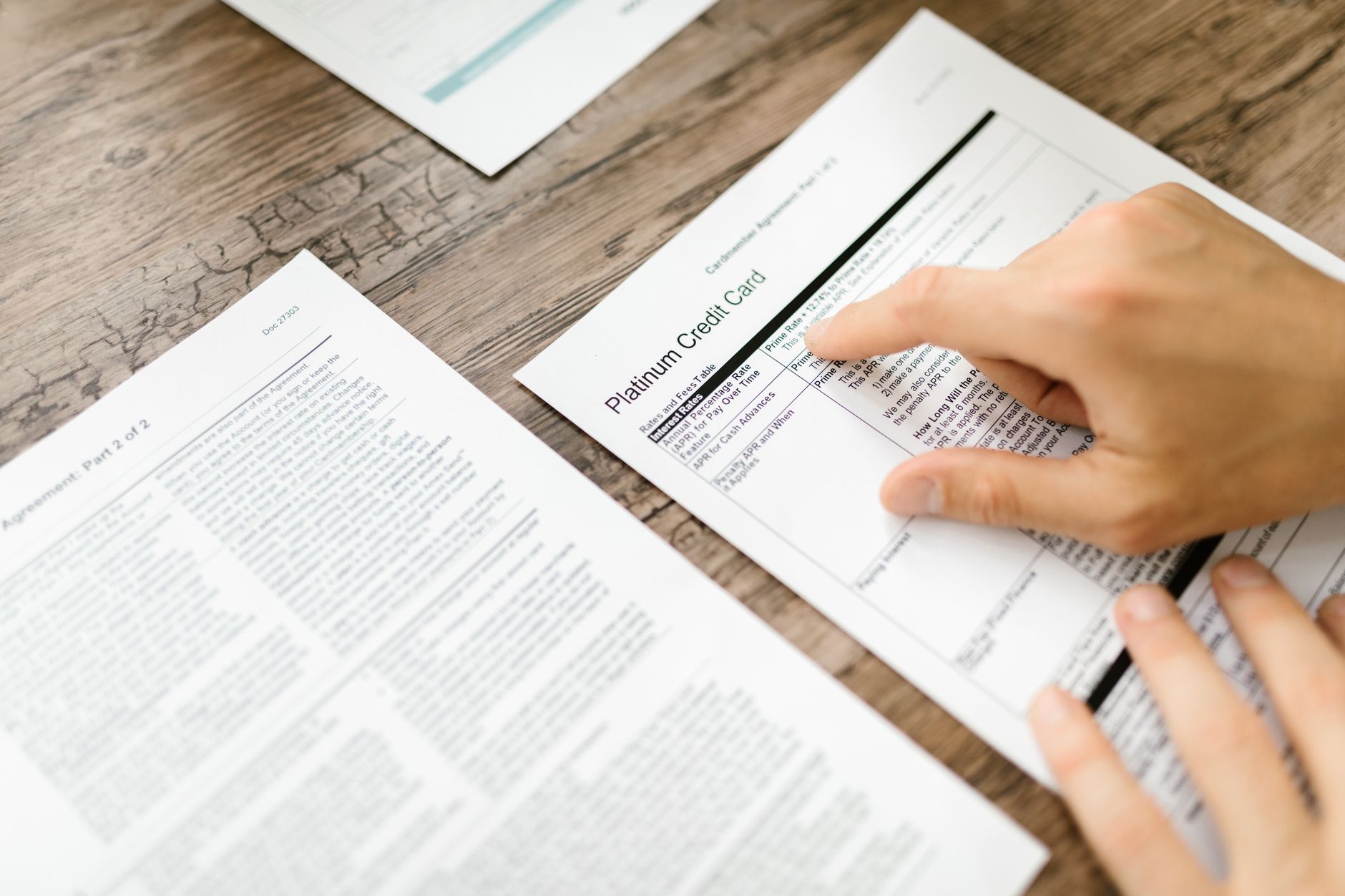 A person reviewing a bank statement with highlighted fee charges on a laptop screen