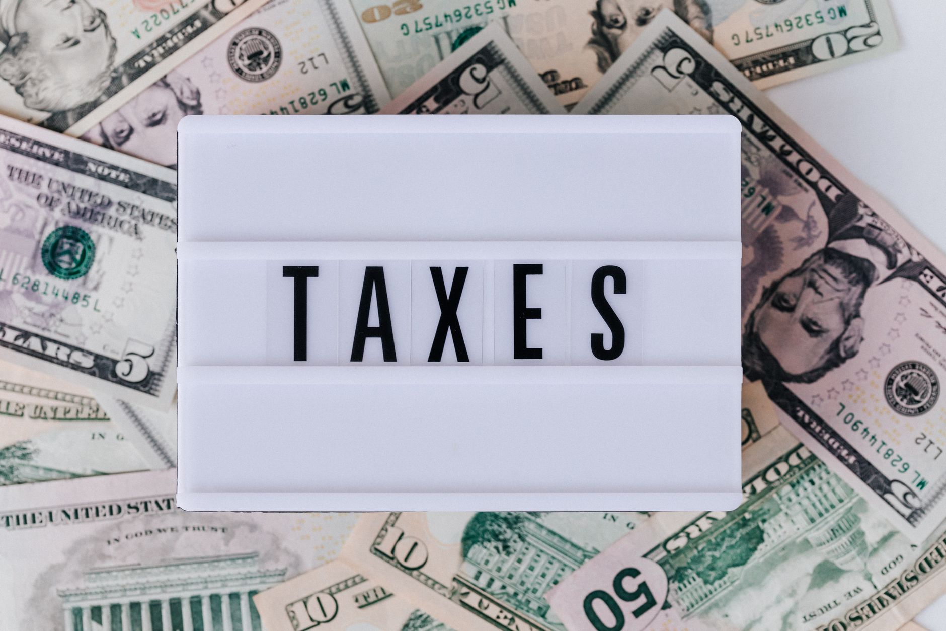 A person reviewing a paycheck stub to avoid a large tax bill