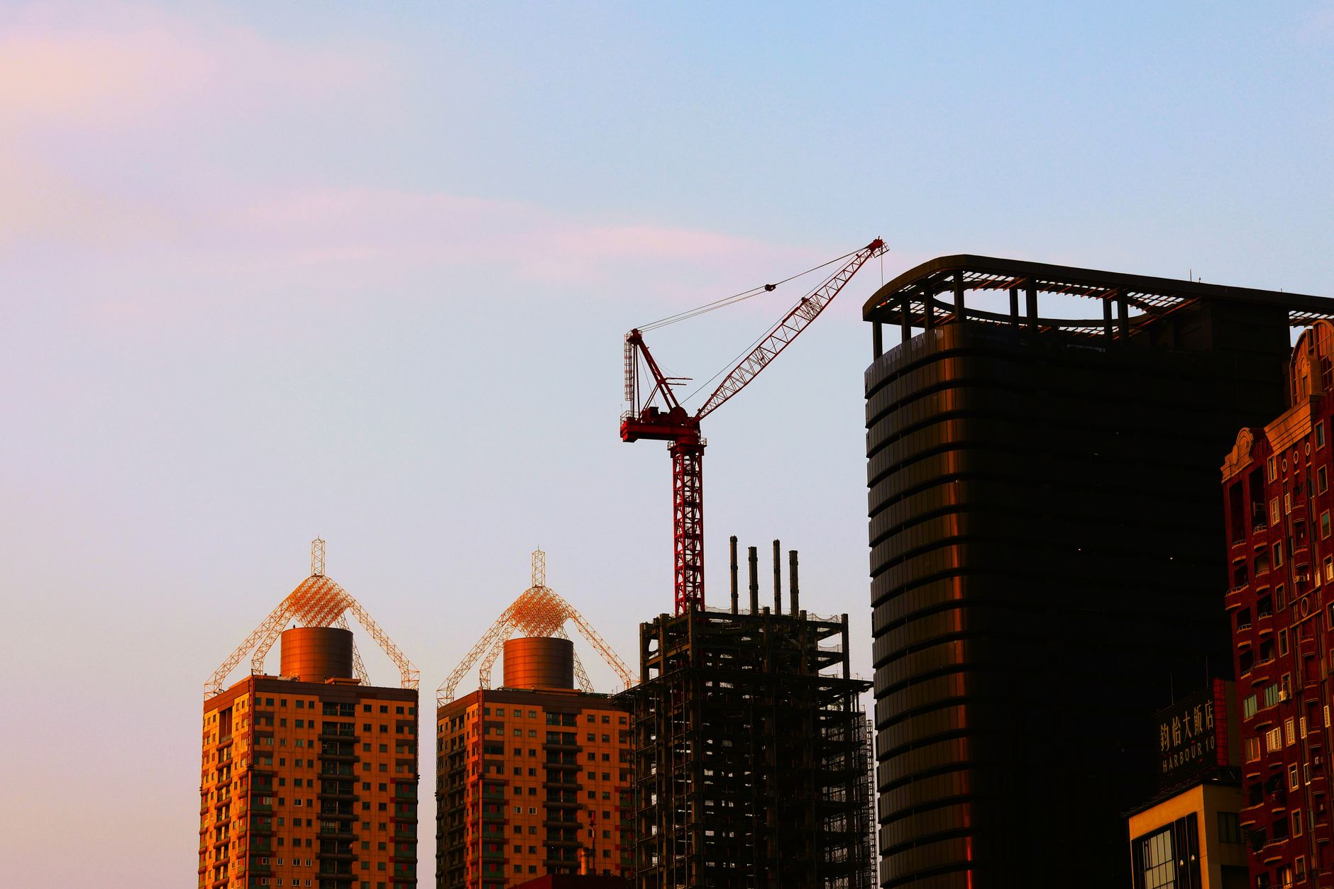 A row of icons representing an apartment building, a warehouse, a storefront, a hospital, and an office tower, illustrating the variety of property sectors that REITs can focus on