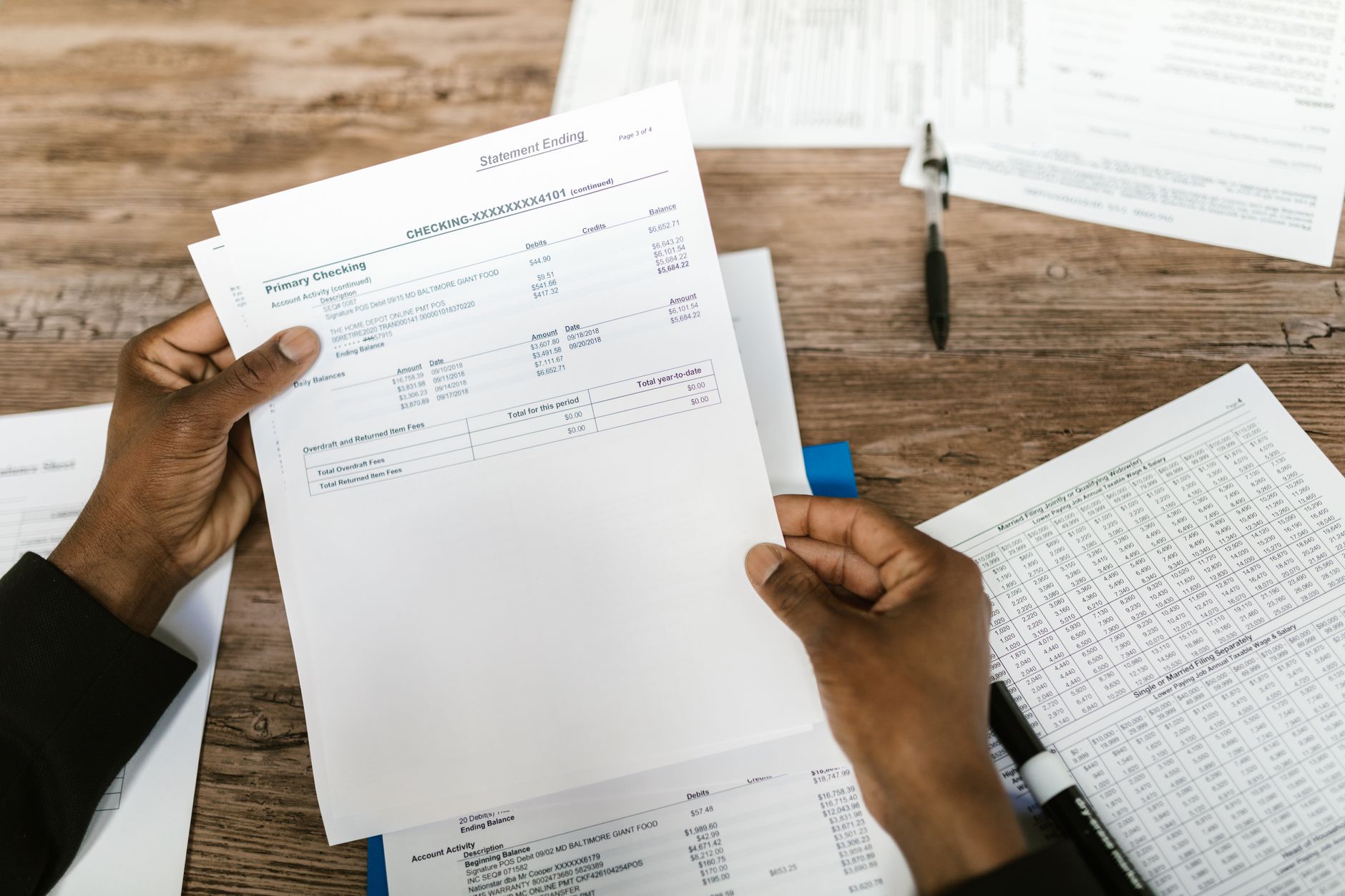 A taxpayer reviews a spreadsheet of itemized deduction categories including mortgage interest, state taxes, and charitable contributions