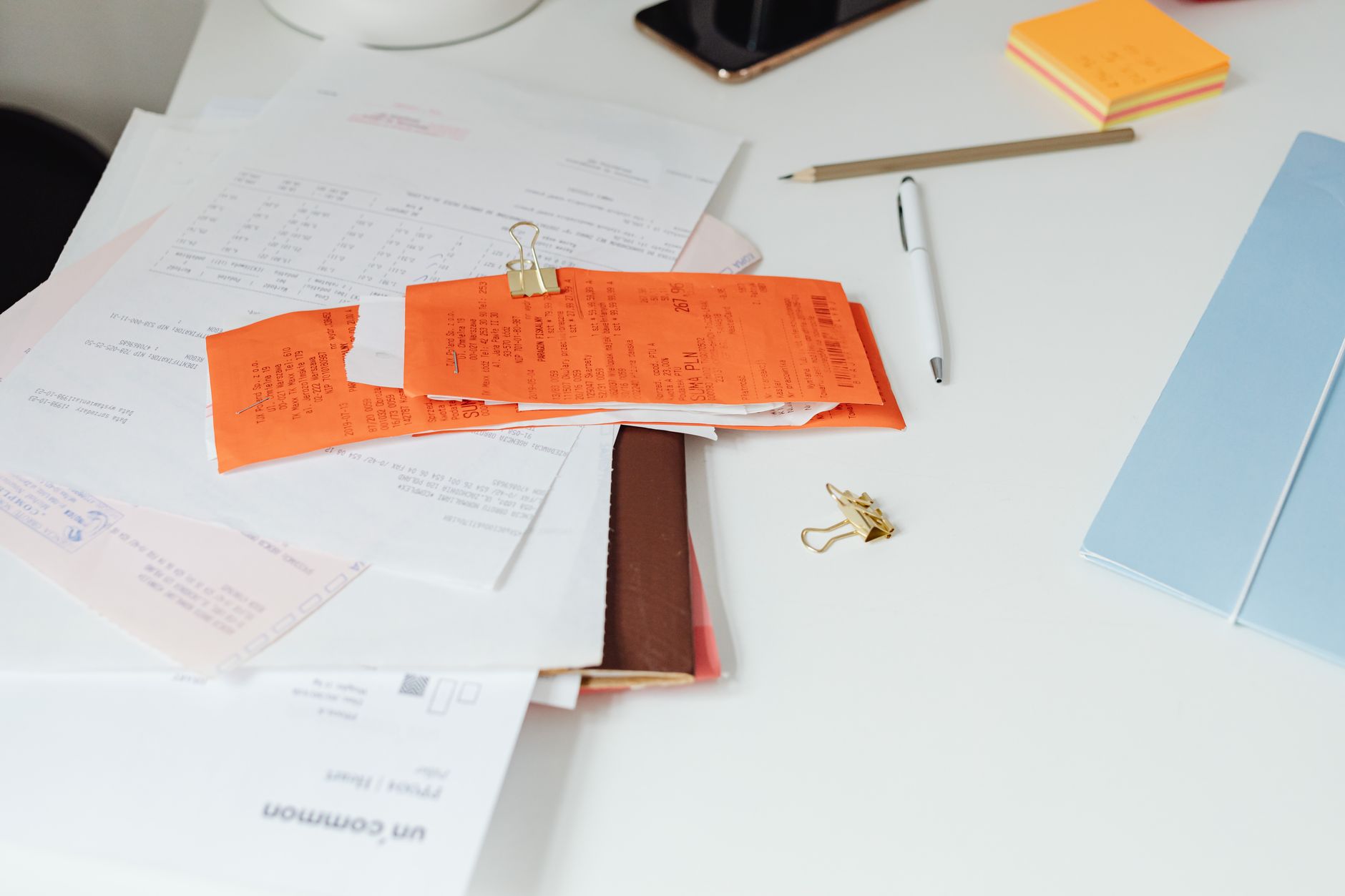 An organized folder with receipts, 1098 forms, and donation letters for tax documentation