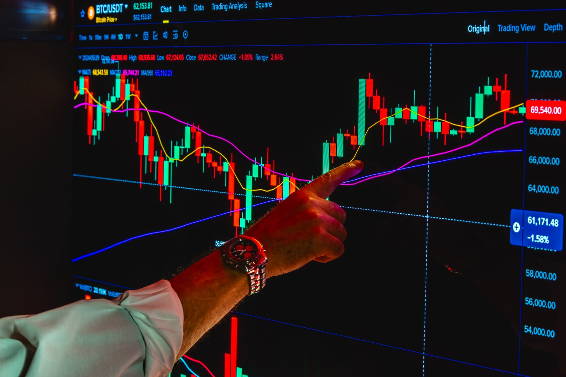 A person at a desk comparing laptop screens showing robo-advisor interface and brokerage account with ETFs