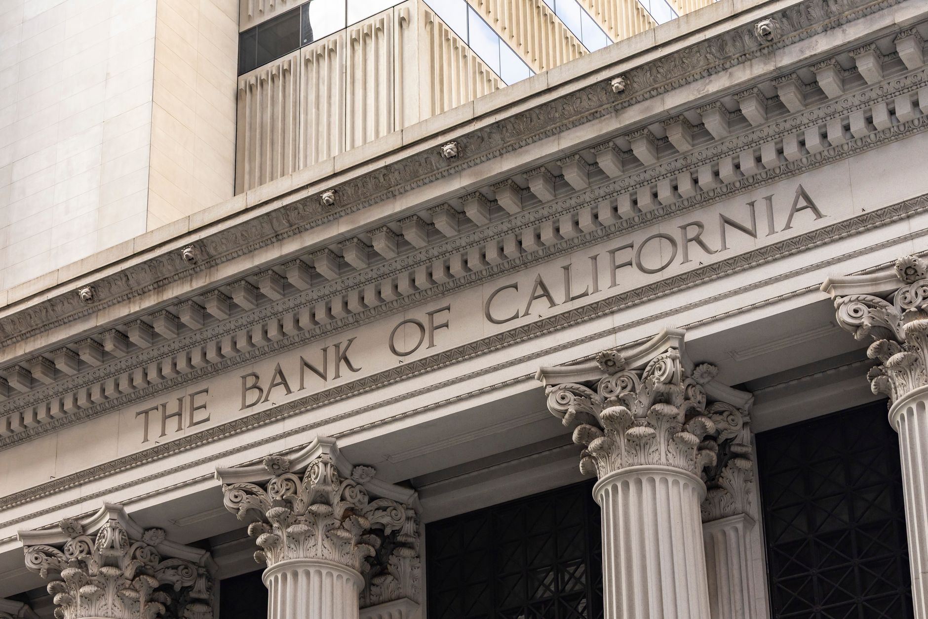 A illustration of a bank building with symbols for technology, nationwide ATM access, and business services